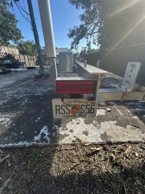 Slide: The Image of Florida trailer with license plate RSS S56, parked outdoors, sunny day. - 38