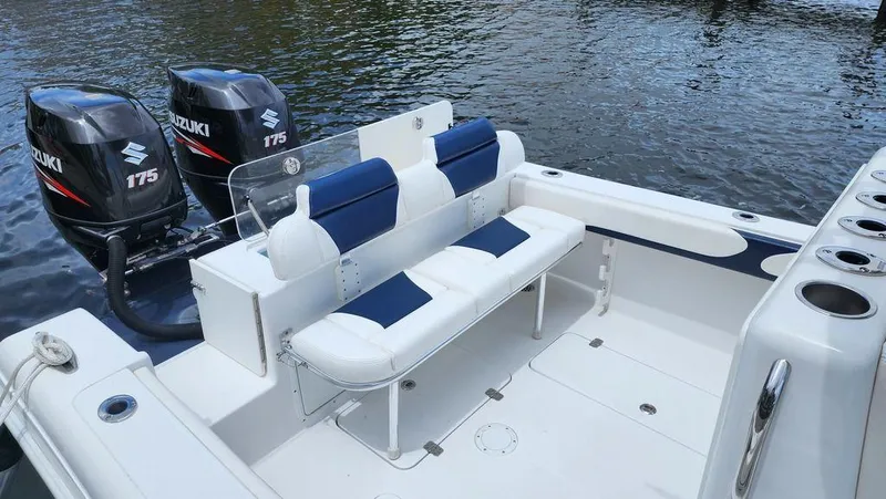 Slide: The Image of 2015 Bluewater 2550 boat with dual Suzuki 175 engines, featuring spacious seating and rod holders. - 9