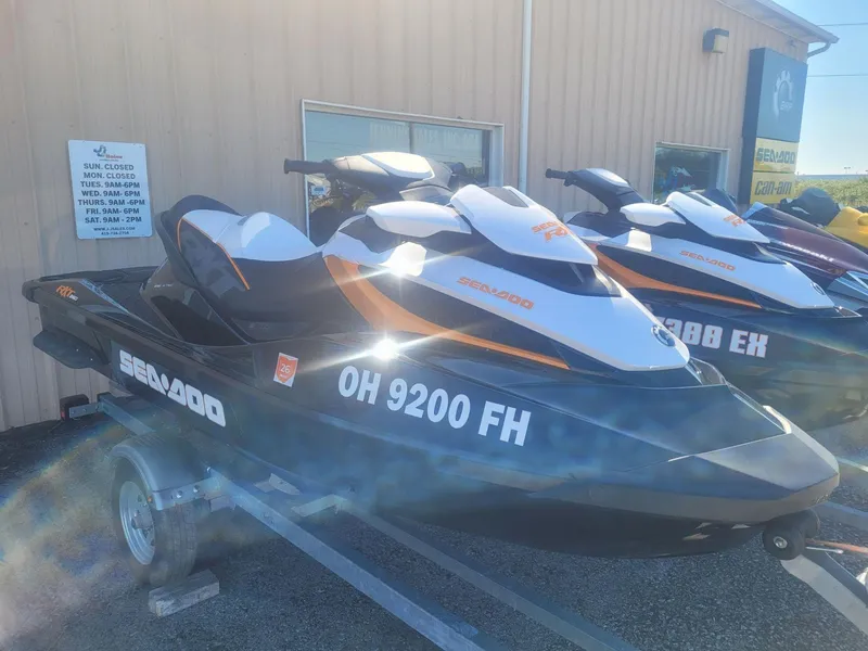 Slide: The Image of 2013 Sea-Doo RXT 260 jet ski on trailer, parked outside a building. - 2