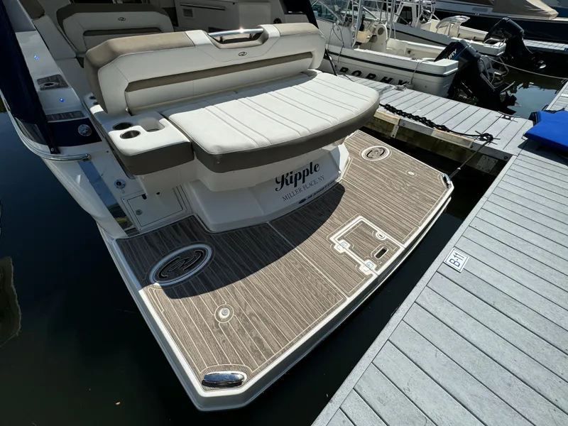 Slide: The Image of 2016 Regal 35 Sport Coupe boat with spacious swim platform at dock. - 10