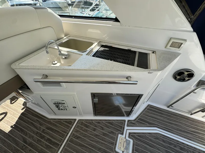 Slide: The Image of 2016 Regal 35 Sport Coupe yacht kitchenette with sink and grill. - 16