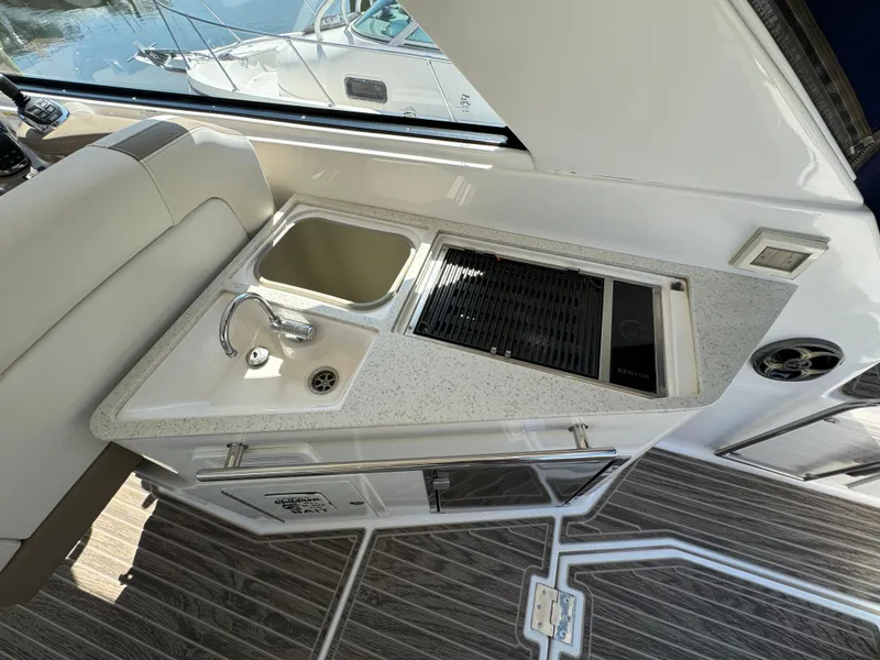 Slide: The Image of 2016 Regal 35 Sport Coupe interior with kitchenette and sink. - 17