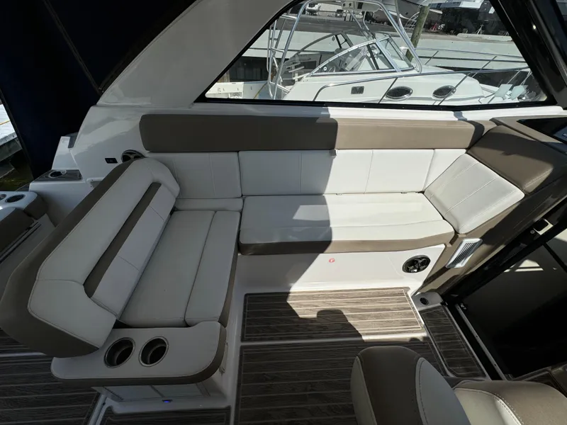 Slide: The Image of 2016 Regal 35 Sport Coupe interior with beige seating and wood flooring. - 22