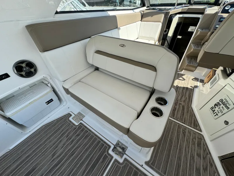 Slide: The Image of Interior of 2016 Regal 35 Sport Coupe with beige seating and cup holders. - 23