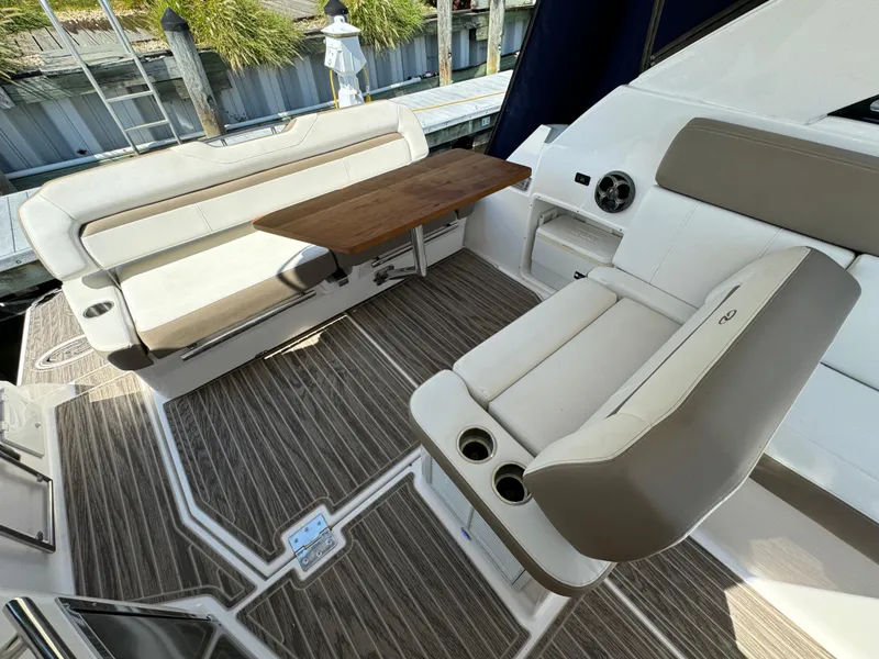 Slide: The Image of 2016 Regal 35 Sport Coupe interior with seating and wooden table. - 28