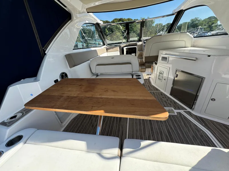 Slide: The Image of Interior of 2016 Regal 35 Sport Coupe with wooden table and seating. - 32