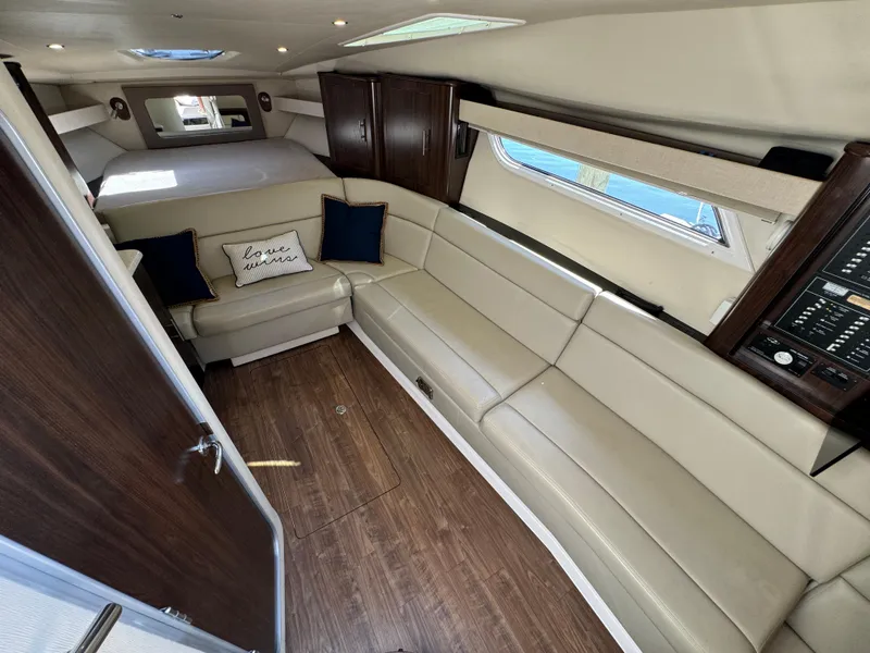 Slide: The Image of Luxurious interior of 2016 Regal 35 Sport Coupe with beige seating and wood accents. - 36