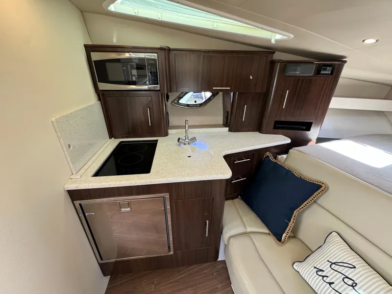 Slide: The Image of 2016 Regal 35 Sport Coupe interior kitchen with modern appliances and sleek cabinetry. - 38