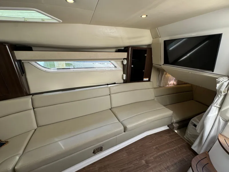 Slide: The Image of Luxurious interior of 2016 Regal 35 Sport Coupe with beige seating and mounted TV. - 39