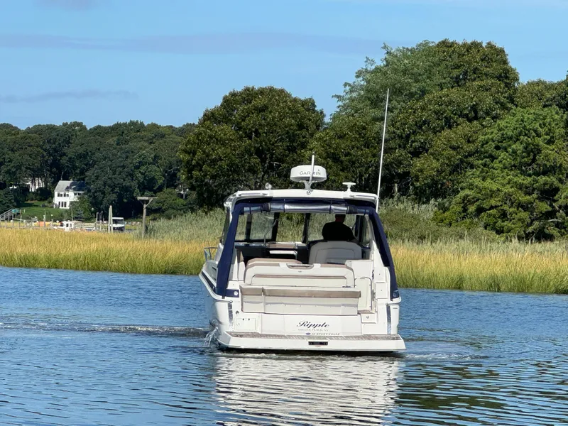 Slide: The Image of 2016 Regal 35 Sport Coupe cruising on a serene river. - 4