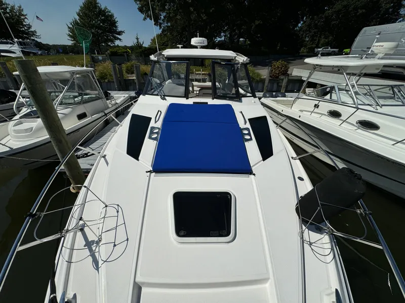 Slide: The Image of 2016 Regal 35 Sport Coupe boat docked, featuring a sleek design and blue sunpad. - 41