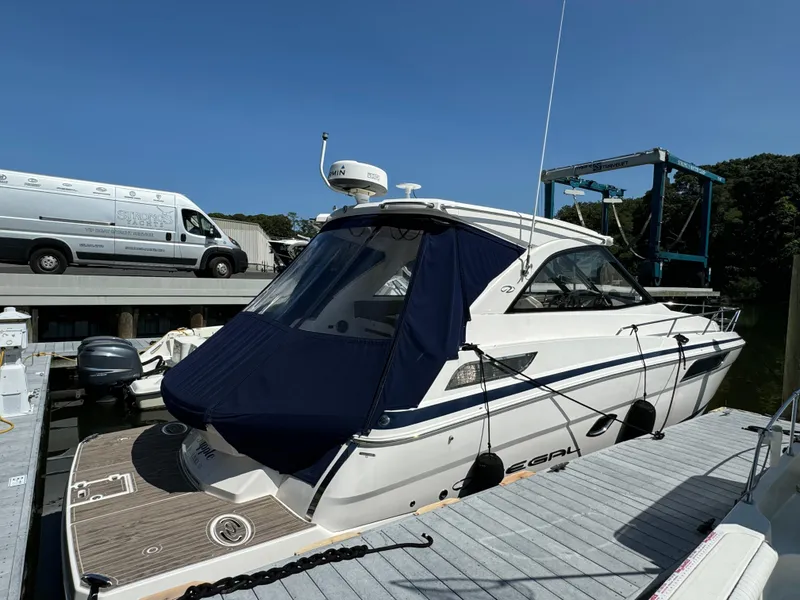Slide: The Image of 2016 Regal 35 Sport Coupe docked at marina under clear blue sky. - 7