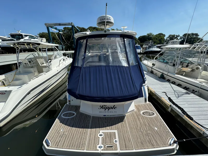 Slide: The Image of 2016 Regal 35 Sport Coupe docked at marina with blue cover. - 8