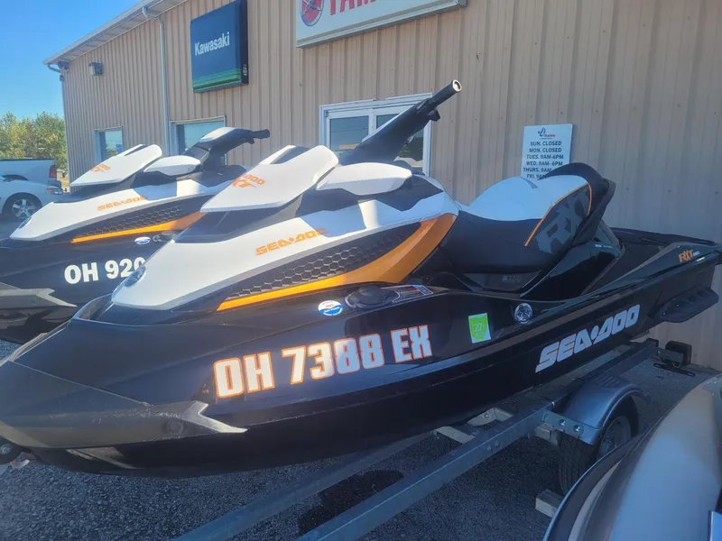 Slide: The Image of 2012 Sea-Doo RXT 260 jet ski on trailer, parked outside dealership. - 2
