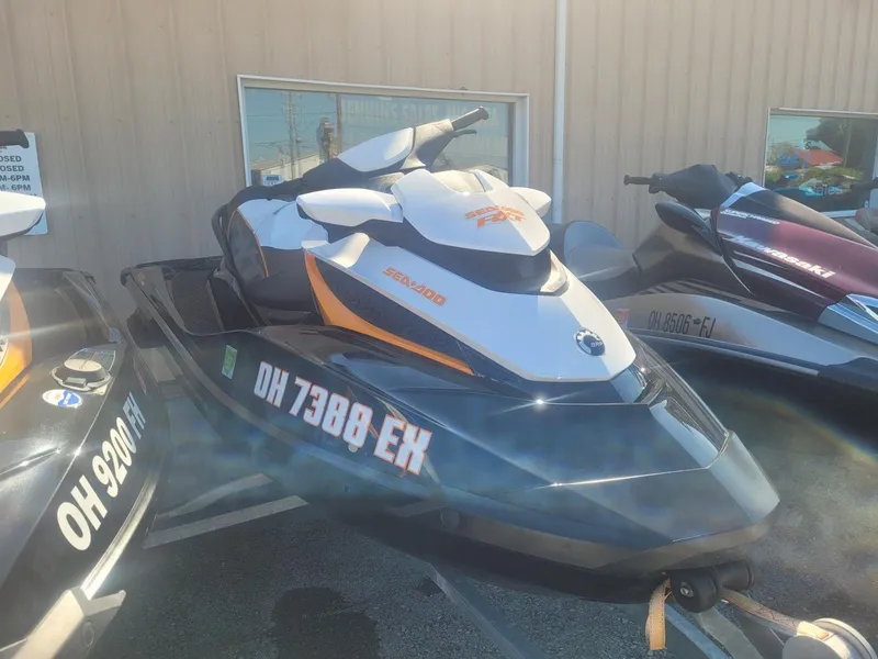 Slide: The Image of 2012 Sea-Doo RXT 260 jet ski parked outdoors. - 3