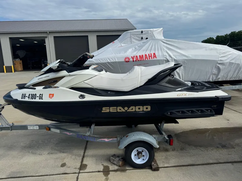 Slide: The Image of 2011 Sea-Doo GTX Limited iS 260 jet ski on trailer, parked outdoors. - 3