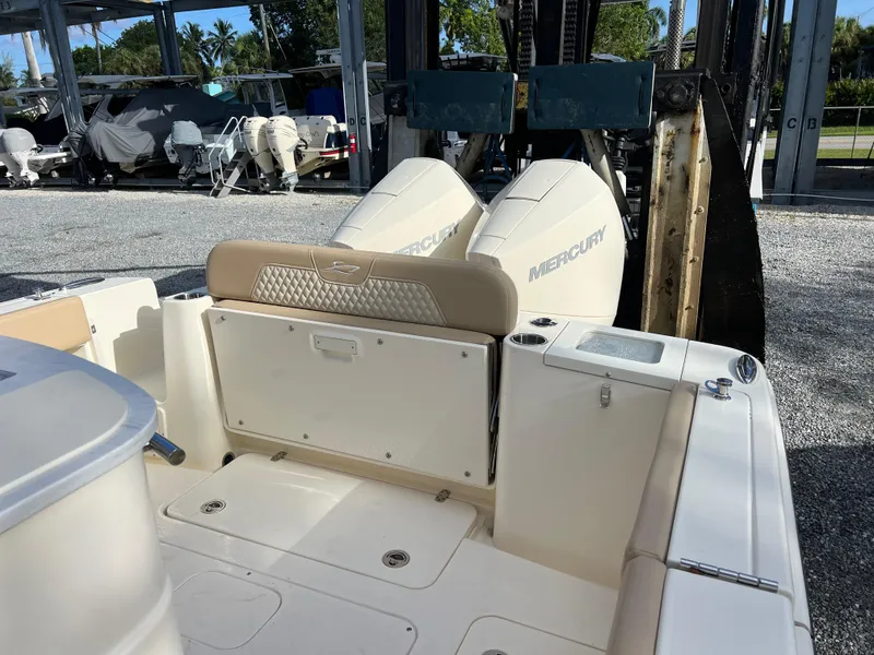 Slide: The Image of 2025 Scout 277 LXF boat with dual Mercury engines in a marina setting. - 10