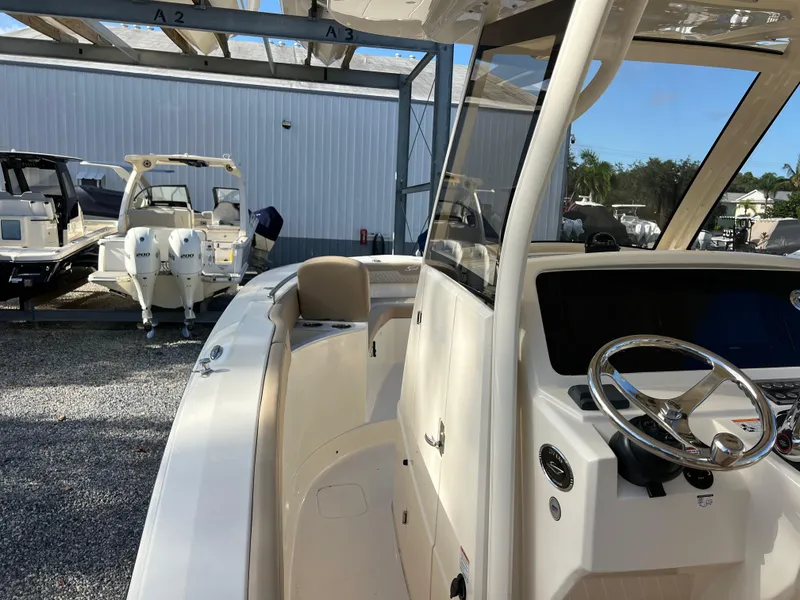 Slide: The Image of 2025 Scout 277 LXF boat interior with steering wheel and seating. - 13