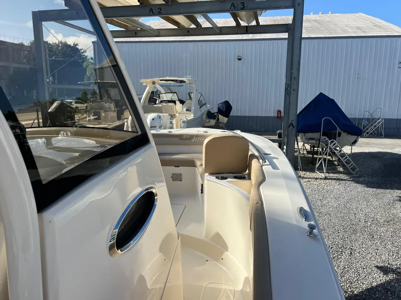 Slide: The Image of 2025 Scout 277 LXF boat in storage facility, side view. - 14