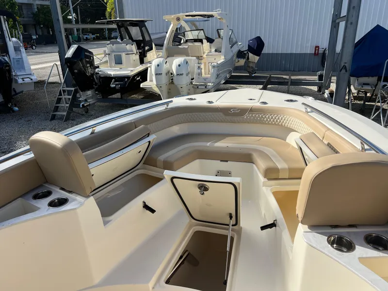 Slide: The Image of 2025 Scout 277 LXF boat interior with beige seating and storage compartments. - 17