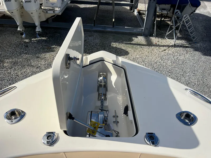 Slide: The Image of 2025 Scout 277 LXF boat anchor compartment with open hatch. - 18