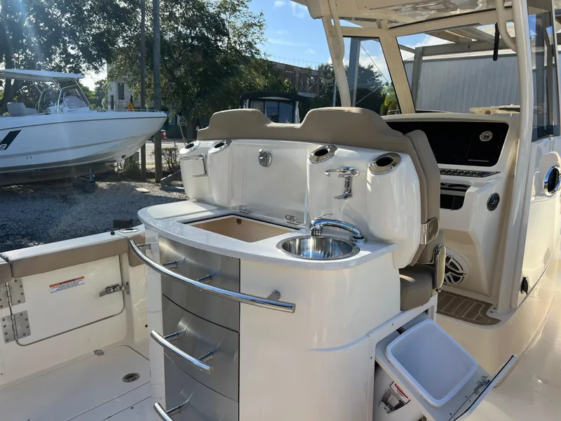 Slide: The Image of 2025 Scout 277 LXF boat interior with sink and storage drawers. - 7