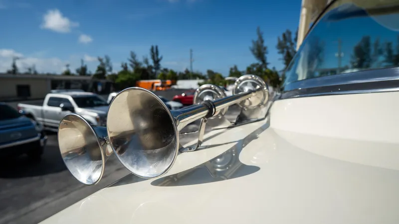 Slide: The Image of 2025 Chris-Craft Launch 31 GT boat with chrome horns, parked outdoors. - 10