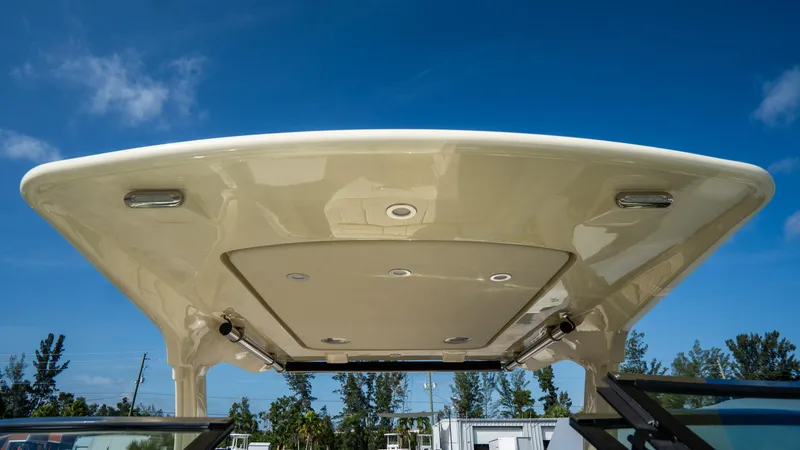 Slide: The Image of 2025 Chris-Craft Launch 31 GT boat canopy under a clear blue sky. - 11