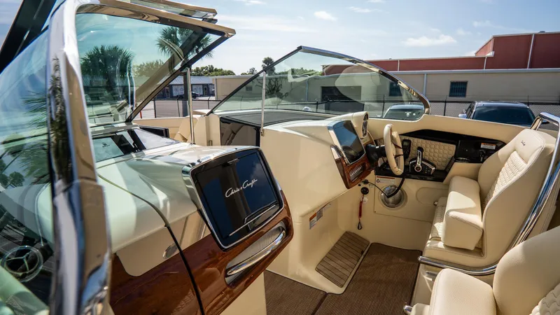 Slide: The Image of Interior of 2025 Chris-Craft Launch 31 GT boat, featuring luxurious seating and modern dashboard. - 14