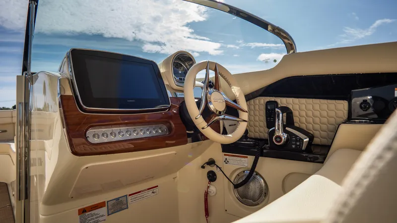 Slide: The Image of 2025 Chris-Craft Launch 31 GT cockpit with modern dashboard and steering wheel. - 15