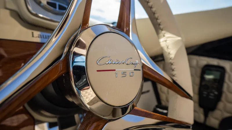 Slide: The Image of Steering wheel of 2025 Chris-Craft Launch 31 GT, featuring elegant wood and chrome design. - 16
