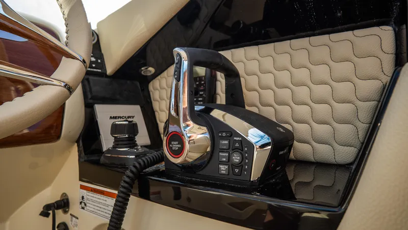 Slide: The Image of 2025 Chris-Craft Launch 31 GT boat control panel with modern throttle and Mercury system. - 19