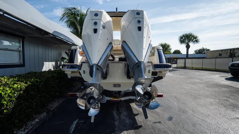 Slide: The Image of 2025 Chris-Craft Launch 31 GT boat with dual outboard engines, parked outdoors. - 2