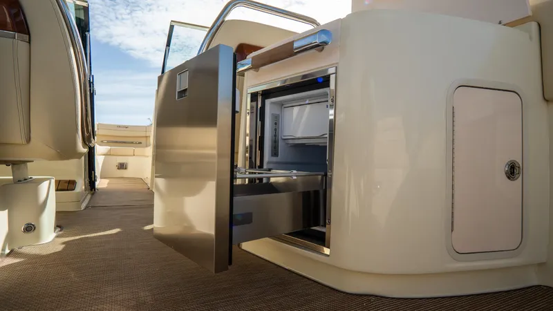 Slide: The Image of 2025 Chris-Craft Launch 31 GT interior with open stainless steel drawer, showcasing luxury design. - 24