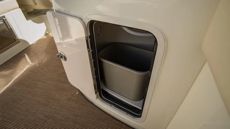 Slide: The Image of 2025 Chris-Craft Launch 31 GT interior storage compartment with trash bin. - 25