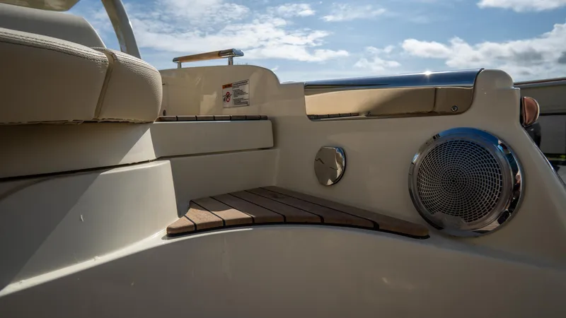 Slide: The Image of 2025 Chris-Craft Launch 31 GT boat interior with speaker and seating under a blue sky. - 32