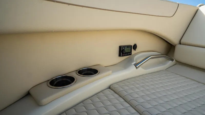Slide: The Image of 2025 Chris-Craft Launch 31 GT interior with beige upholstery and cup holders. - 8
