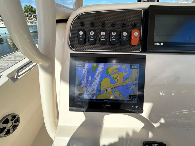 Slide: The Image of 2021 Grady-White Fisherman 216 dashboard with Garmin navigation display and control panel. - 11