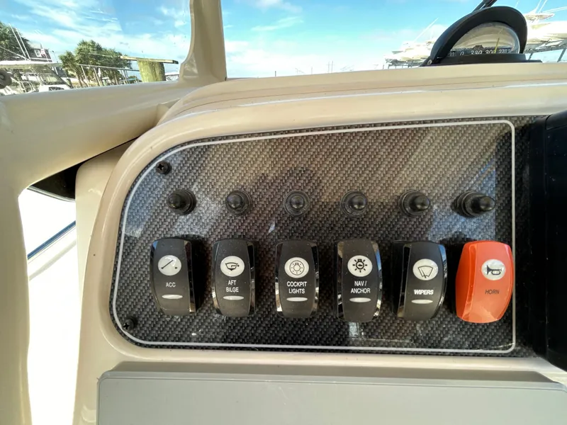 Slide: The Image of Control panel of 2021 Grady-White Fisherman 216 boat with labeled switches. - 14