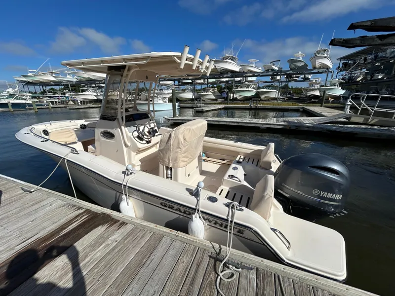Slide: The Image of 2021 Grady-White Fisherman 216 boat docked at marina with Yamaha engine. - 2