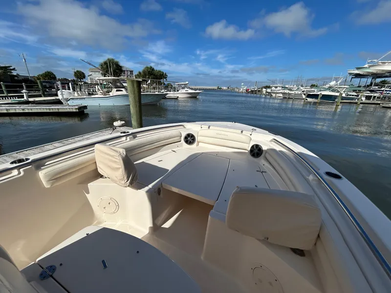 Slide: The Image of 2021 Grady-White Fisherman 216 boat docked at a marina under a clear blue sky. - 22