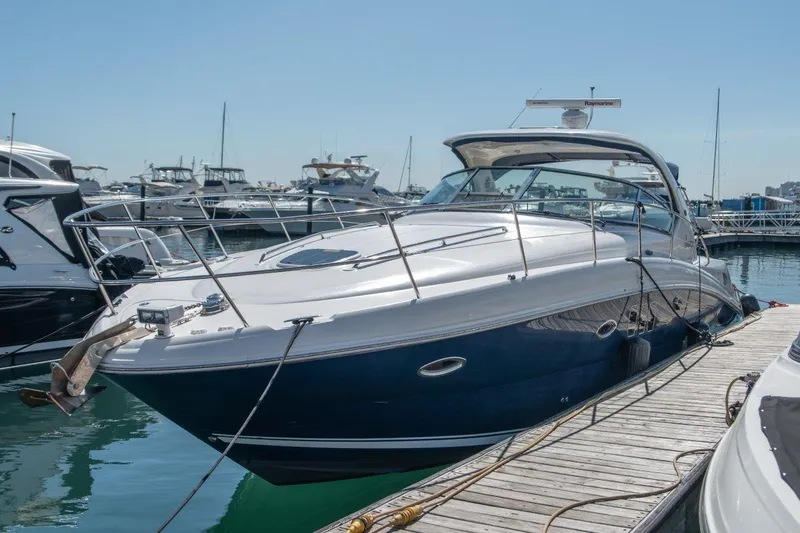 The Image of 2008 Sea Ray 380 Sundancer yacht docked at marina, clear sky background. - 0