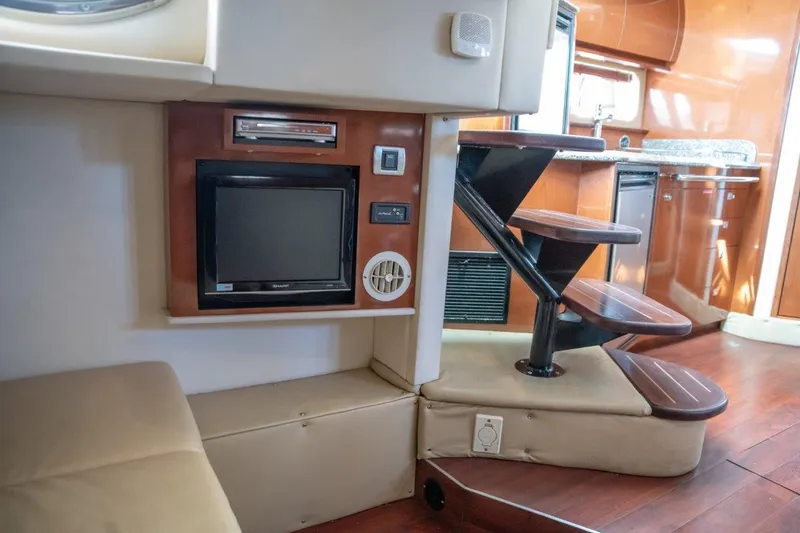 Slide: The Image of Interior of 2008 Sea Ray 380 Sundancer yacht with TV and wooden stairs. - 10