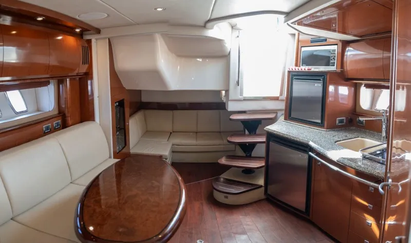 Slide: The Image of Luxurious interior of 2008 Sea Ray 380 Sundancer yacht with modern kitchen and seating area. - 11