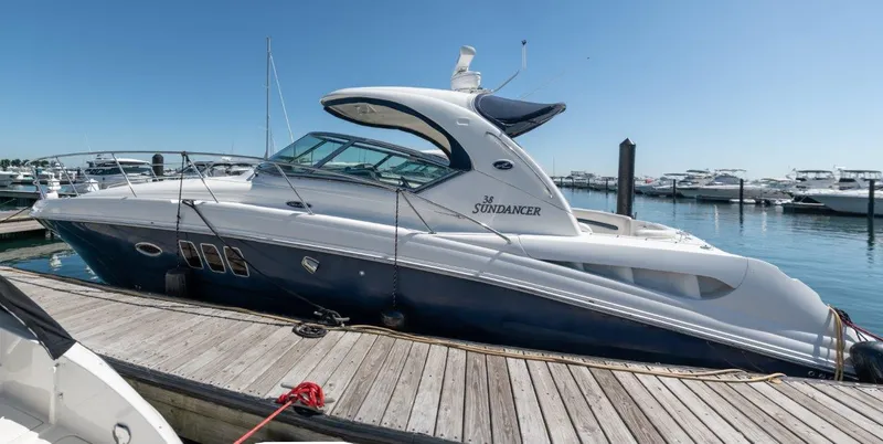 Slide: The Image of 2008 Sea Ray 380 Sundancer yacht docked at marina under clear blue sky. - 2