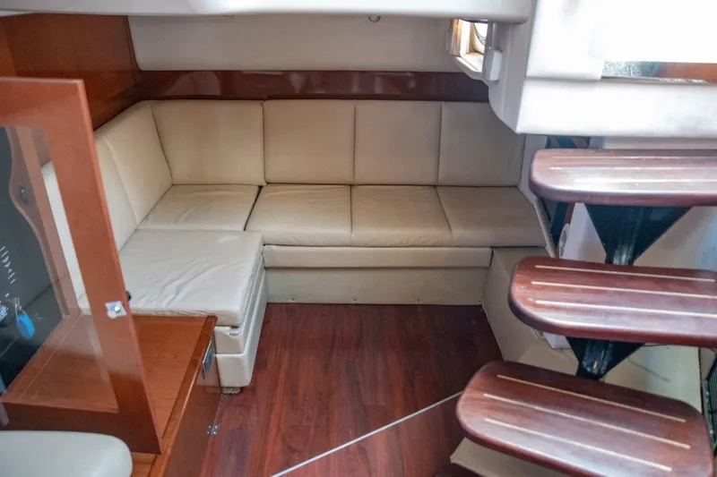 Slide: The Image of Interior of 2008 Sea Ray 380 Sundancer with beige seating and wooden flooring. - 8