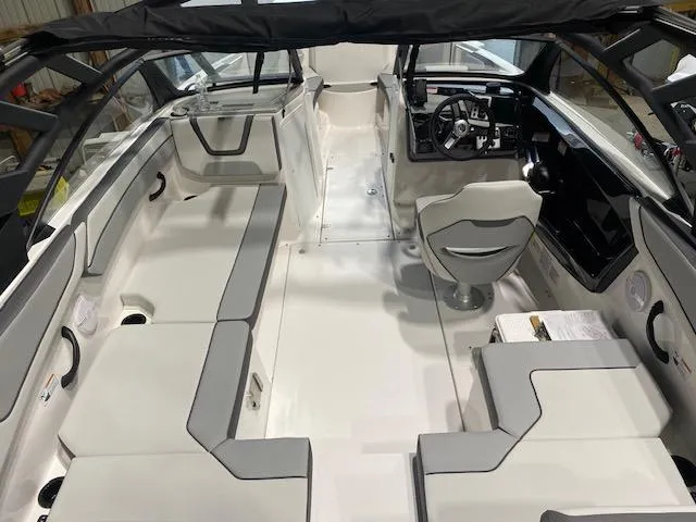 Slide: The Image of 2025 Yamaha Boats AR220 interior with sleek seating and modern dashboard. - 2