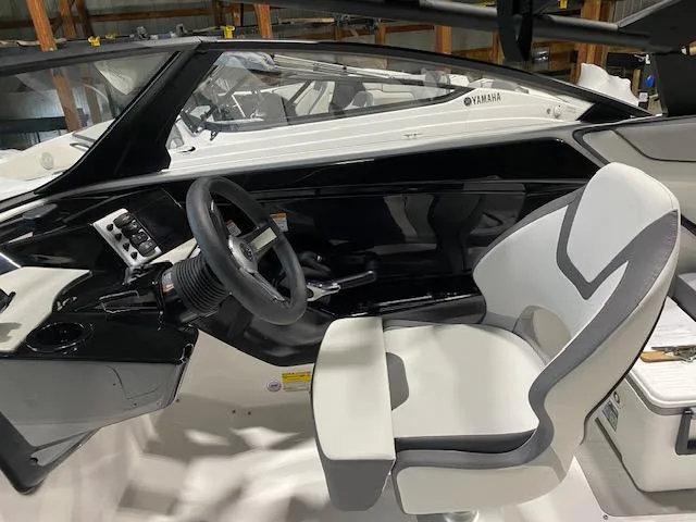 Slide: The Image of 2025 Yamaha Boats AR220 cockpit with sleek steering and modern seating. - 3
