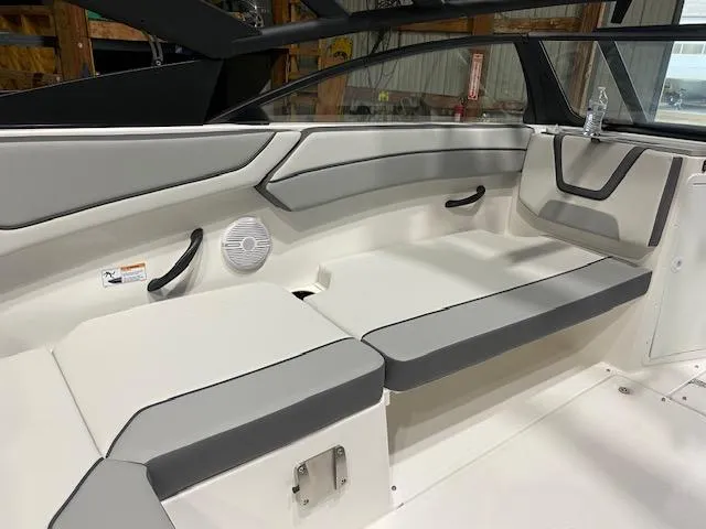 Slide: The Image of 2025 Yamaha Boats AR220 interior seating with gray and white upholstery. - 5