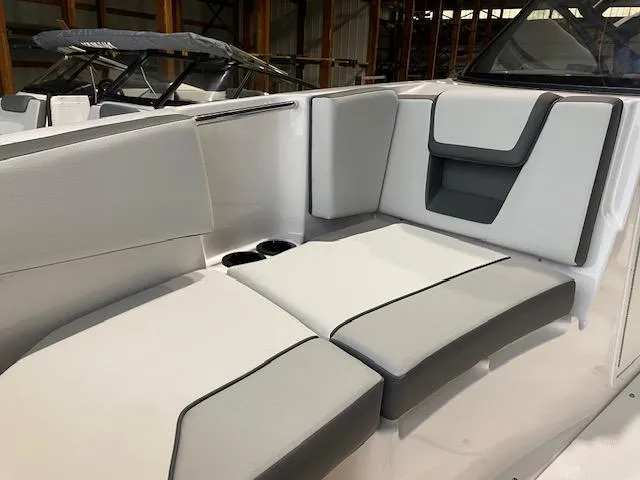 Slide: The Image of 2025 Yamaha Boats AR220 interior with sleek, modern seating and cup holders. - 6